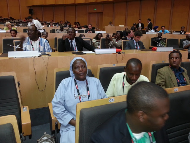 Sr. Clare Migisha inside the Mandela Conference hall listening to keynote speakers